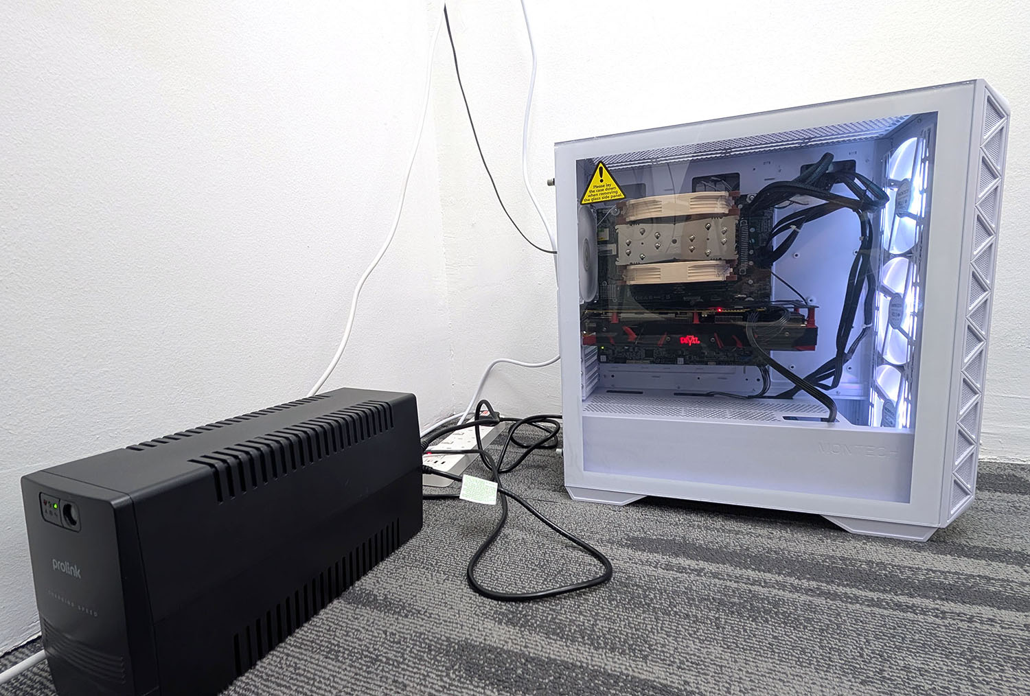 The PC in a running state, hooked up to our UPS.